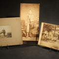 Lot 111 - Trio of Antique Board-Mounted Photographs Including a Cabinet Card of a Boy with Violin, by Hardy, Boston, a Horse-Drawn Carriage Party by J. P. Haseltine, Lancaster, New Hampshire, and a Man Posed with Cannons, by Hollis Studio, Boston