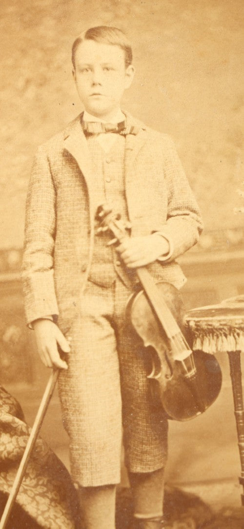 Trio of Antique Board-Mounted Photographs Including a Cabinet Card of a Boy with Violin, by Hardy, Boston, a Horse-Drawn Carriage Party by J. P. Haseltine, Lancaster, New Hampshire, and a Man Posed with Cannons, by Hollis Studio, Boston