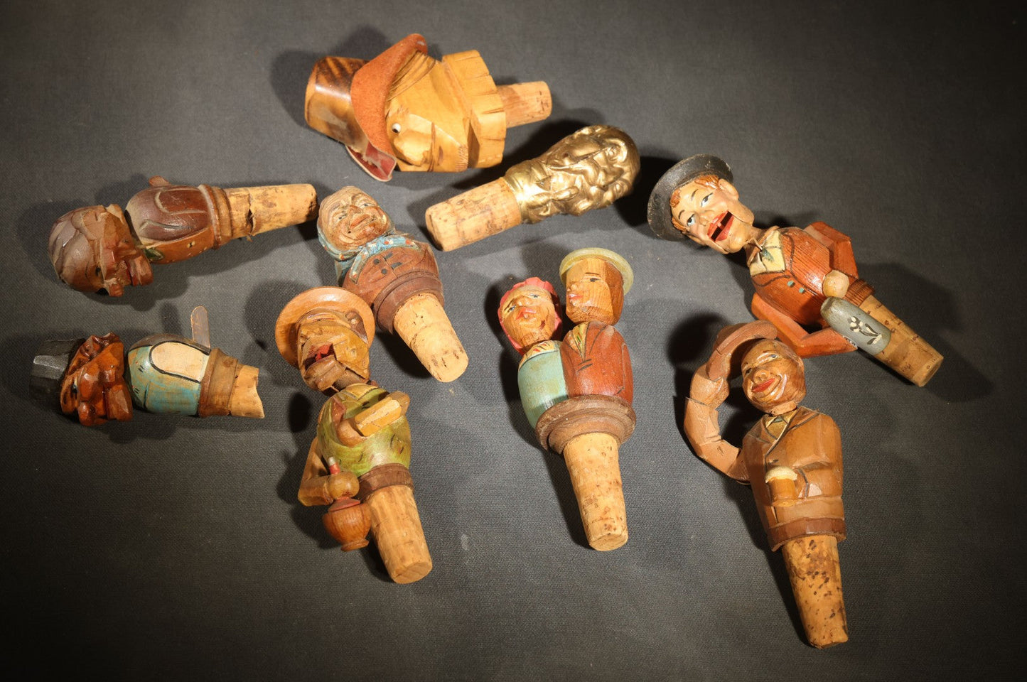 Grouping of Nine Vintage Carved and Painted Wood Figural Bottle Stoppers Including Animated Examples