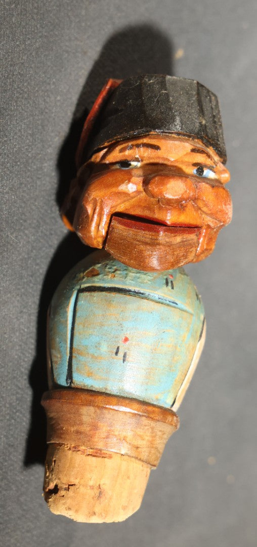 Grouping of Nine Vintage Carved and Painted Wood Figural Bottle Stoppers Including Animated Examples
