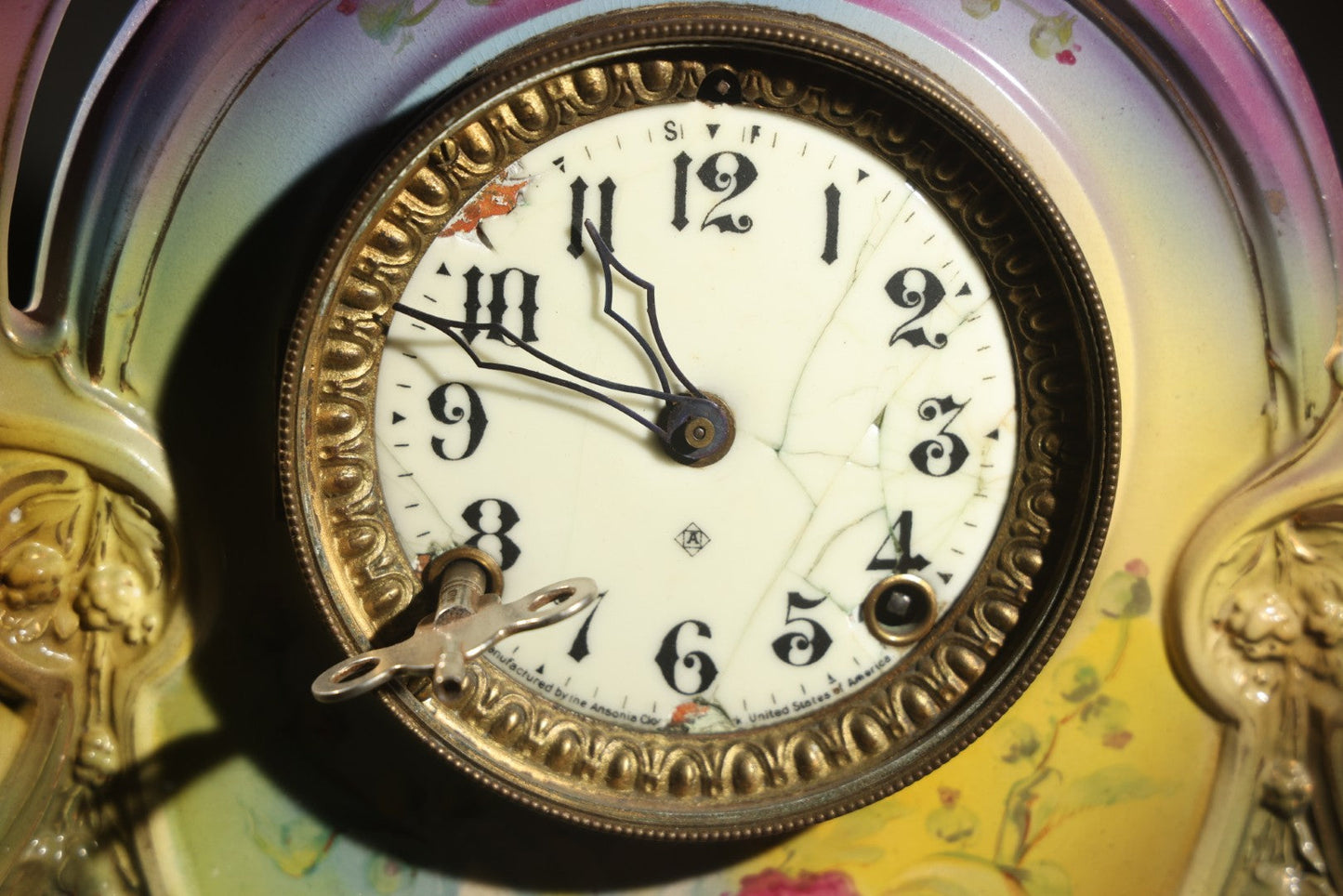 Antique Art Nouveau Porcelain Mantel Clock with Figural Head and Floral Decoration, Ansonia Clock Company, Bonn Germany, note severe damage to dial