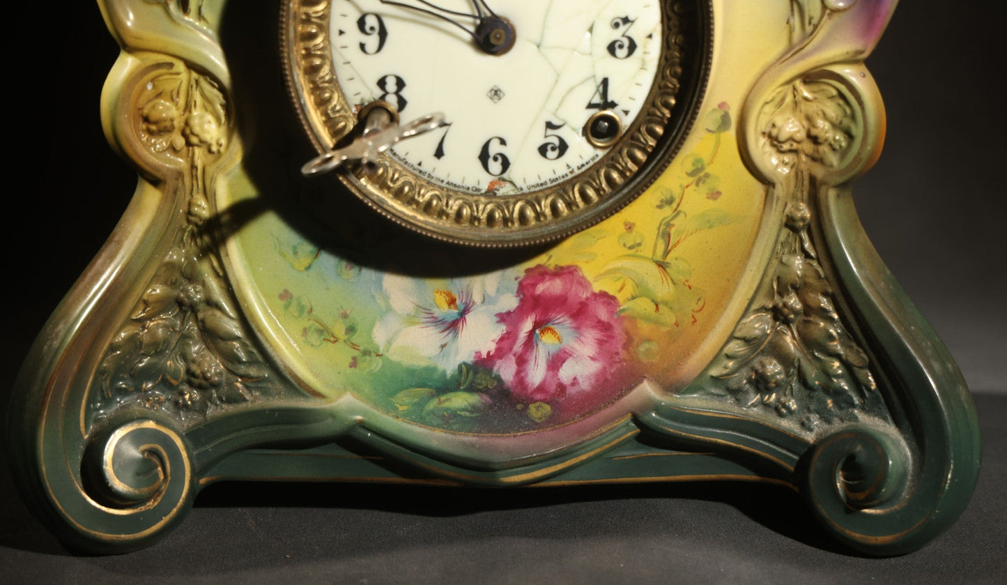 Antique Art Nouveau Porcelain Mantel Clock with Figural Head and Floral Decoration, Ansonia Clock Company, Bonn Germany, note severe damage to dial