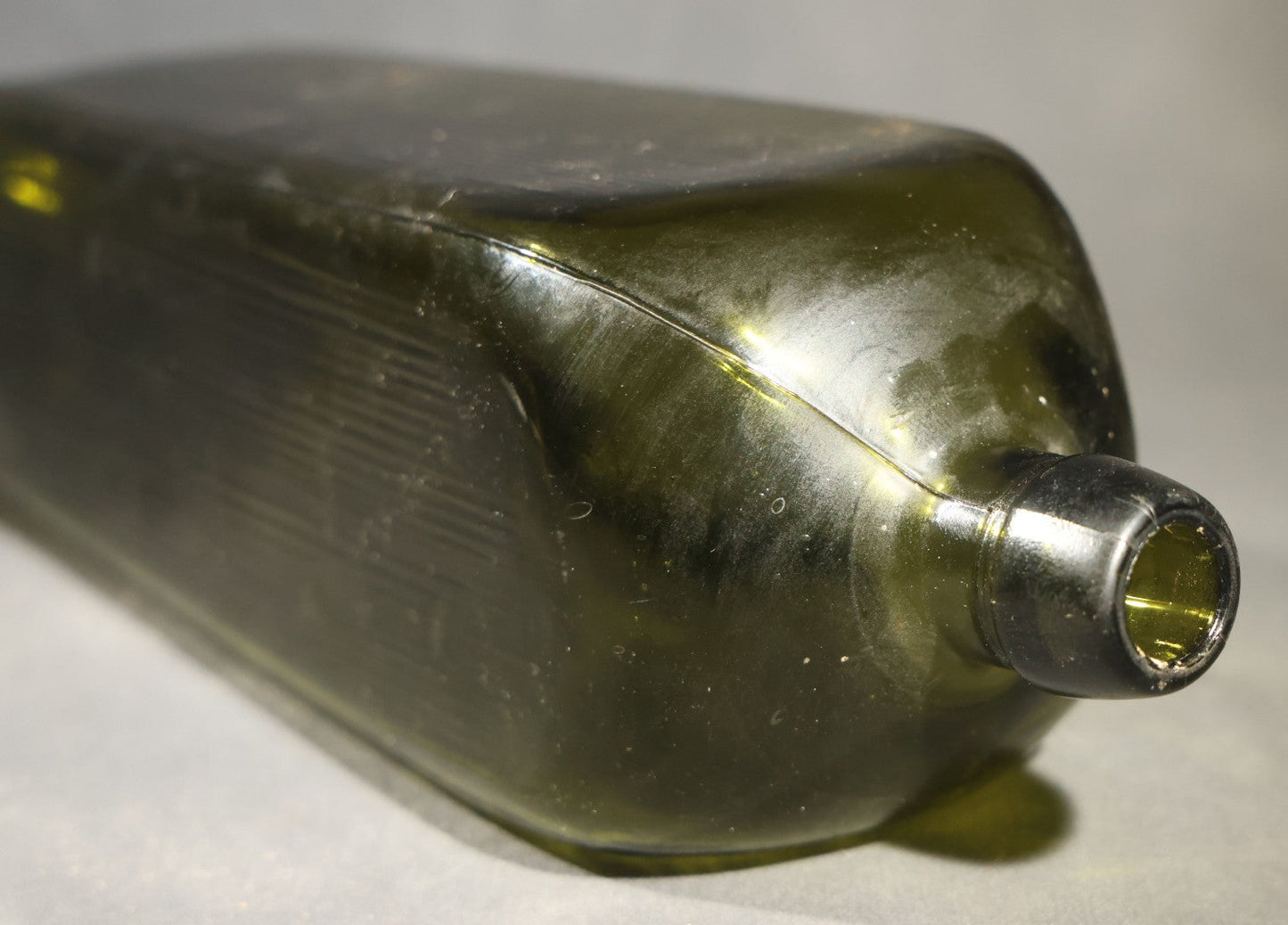 Grouping of Five Antique Case Bottles, Olive Green and Amber Glass, Tapered Square Form, Possible Gin Bottles, 19th Century & 20th century