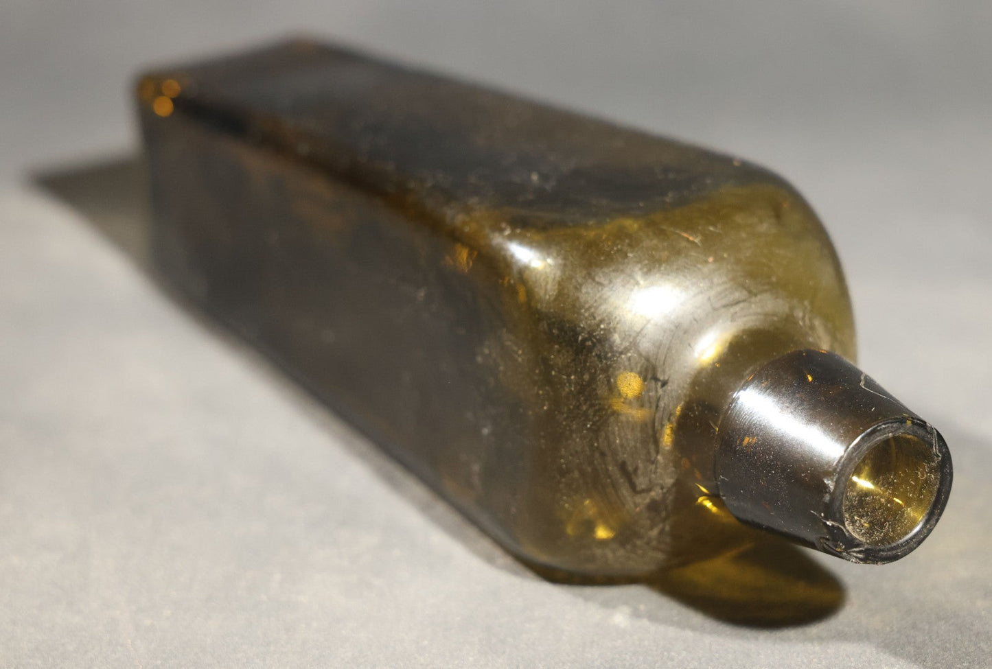 Grouping of Five Antique Case Bottles, Olive Green and Amber Glass, Tapered Square Form, Possible Gin Bottles, 19th Century & 20th century