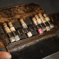 Lot 025 - Antique Leather Medical Kit Traveling Apothecary with Seven Glass Medicine Vials Including Aspirin and Headache Remedies, 8" L