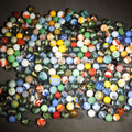 Lot 031 - Grouping of 200+ Vintage Glass Marbles Including UV-Reactive Green and Cadmium Orange Glowers with Swirls, Patches, Cat's Eyes, Solids, and Ribbon Core Examples