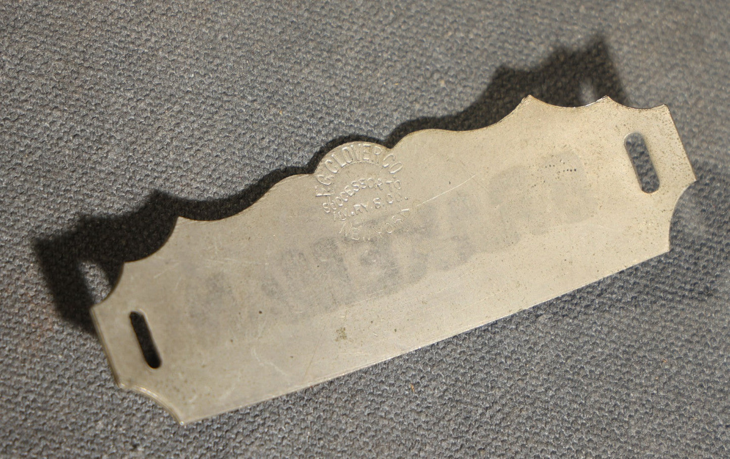 Grouping of four Vintage Railway Employee Badges and Tags including Walkway Over the Hudson Cantilever Bridge Pin, Pullman 19 C.E. Brass Tag, Baldwin A-3107 Special Photo emplopye ID badge, and Brakeman Metal Badge