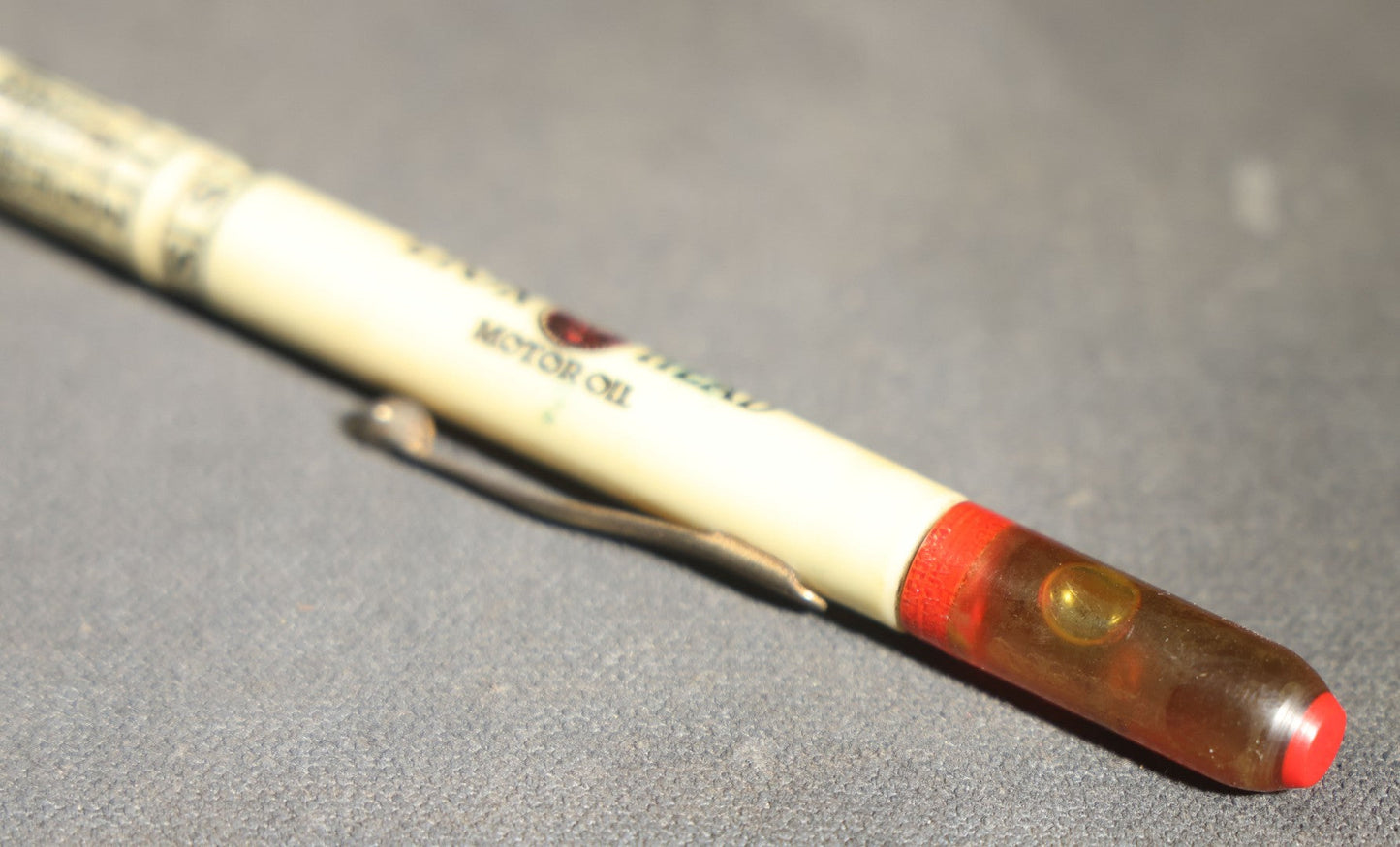 Pair of Vintage Advertising Items, Rheingold Beer Foam Scraper and Lion Head Motor Oil Pencil with real oil sample