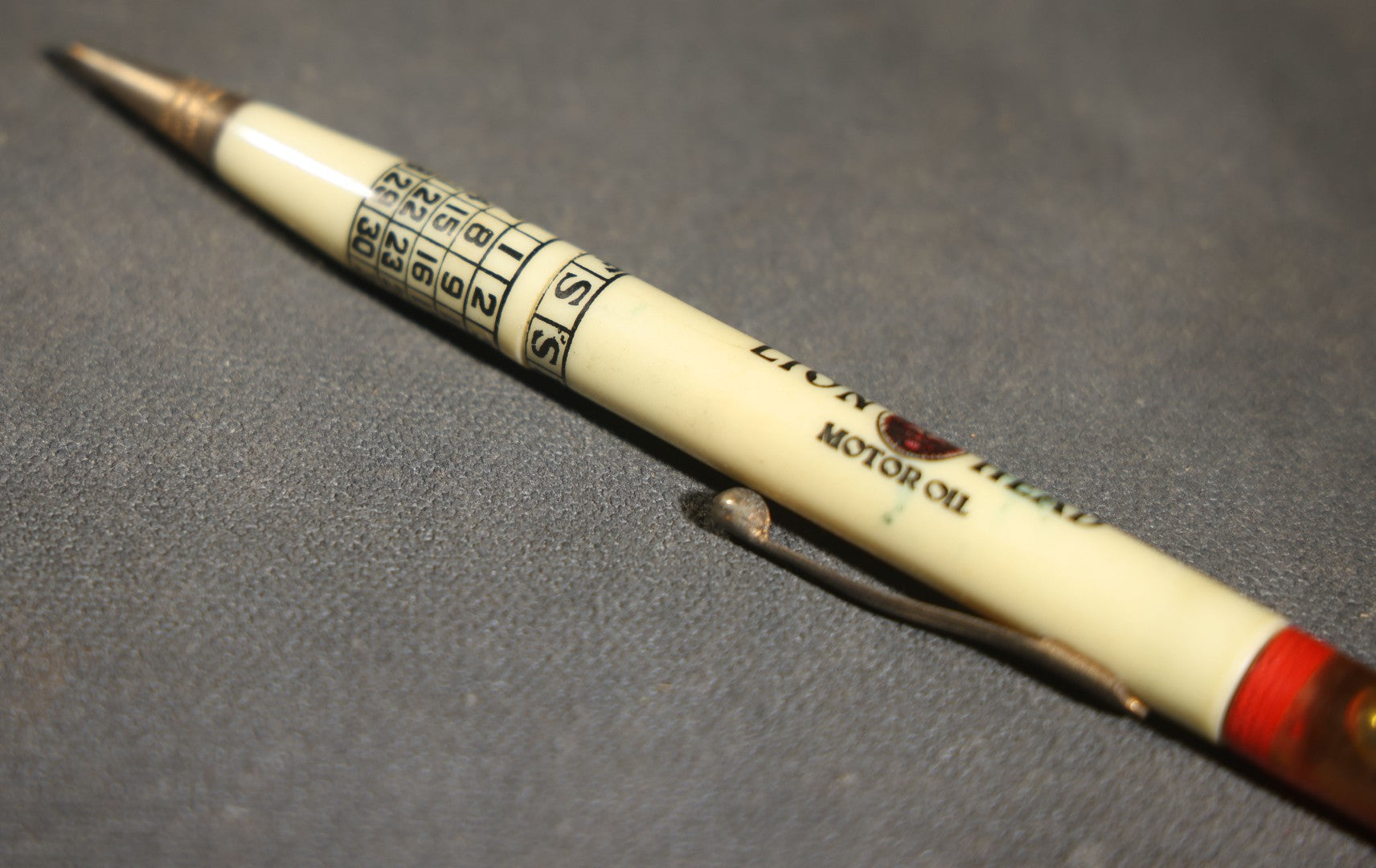 Pair of Vintage Advertising Items, Rheingold Beer Foam Scraper and Lion Head Motor Oil Pencil with real oil sample