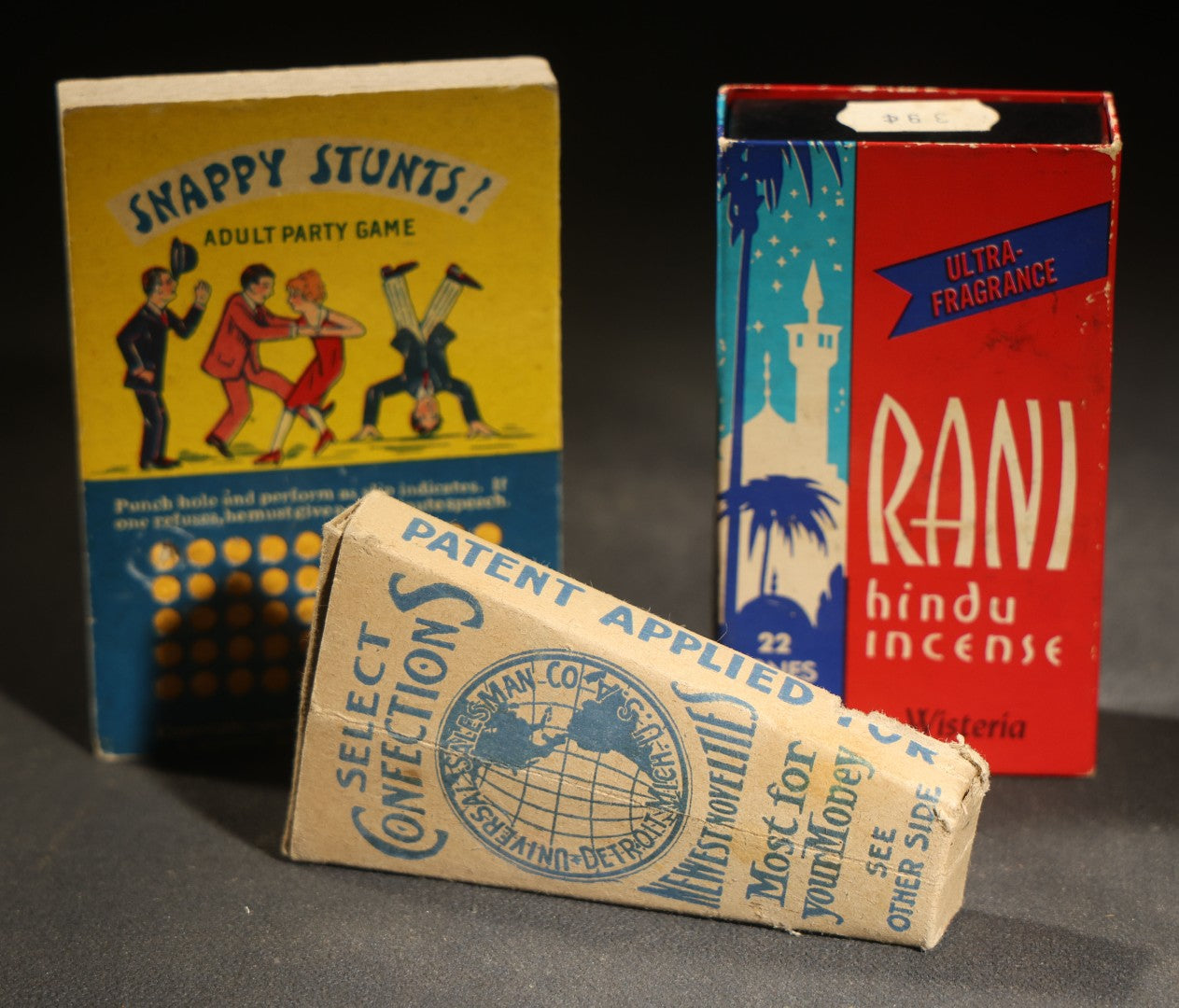 Trio of Vintage Novelty Boxes including Rani Hindu Incense Room Deodorant by Hindu Incense Chicago 1974, Snappy Stunts Adult Party Game by A. Master Brooklyn, and Select Confections by Universal Salesman Co.