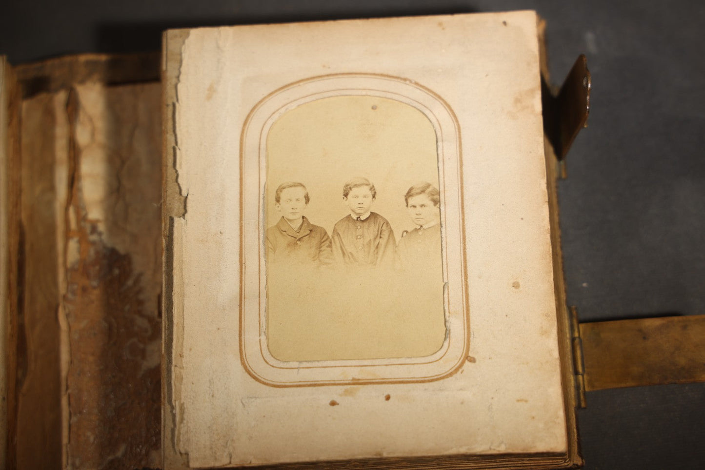 Antique Portrait Photo Album Containing 15 Tintype Photographs and 29 C.D.V. Photographs, Including Hand-Tinted Tintype Examples, note binding in poor condition