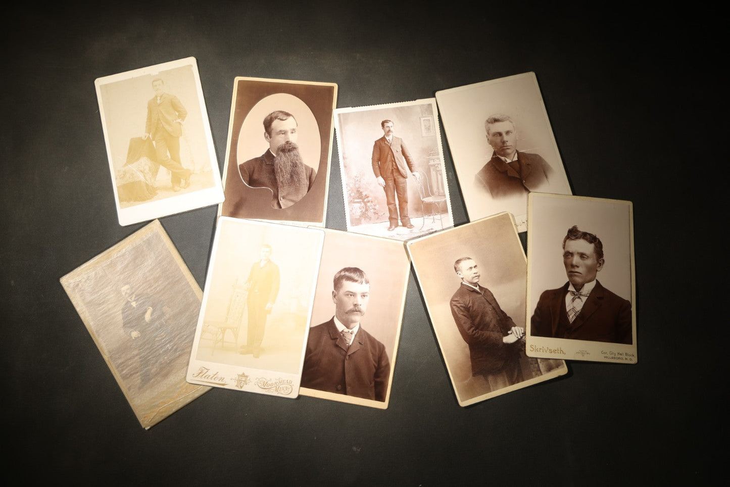 Grouping of Nine Antique Cabinet Card Photographs of Men including Examples by McInnis, Skrivseth, and Flaten