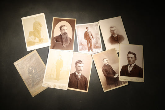 Grouping of Nine Antique Cabinet Card Photographs of Men including Examples by McInnis, Skrivseth, and Flaten