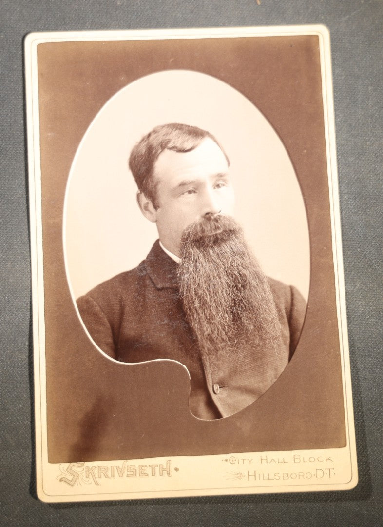 Grouping of Nine Antique Cabinet Card Photographs of Men including Examples by McInnis, Skrivseth, and Flaten