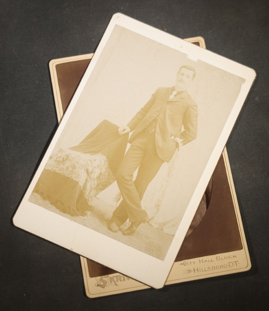 Grouping of Nine Antique Cabinet Card Photographs of Men including Examples by McInnis, Skrivseth, and Flaten