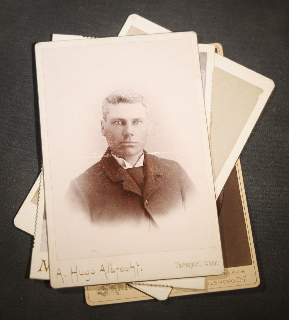 Grouping of Nine Antique Cabinet Card Photographs of Men including Examples by McInnis, Skrivseth, and Flaten