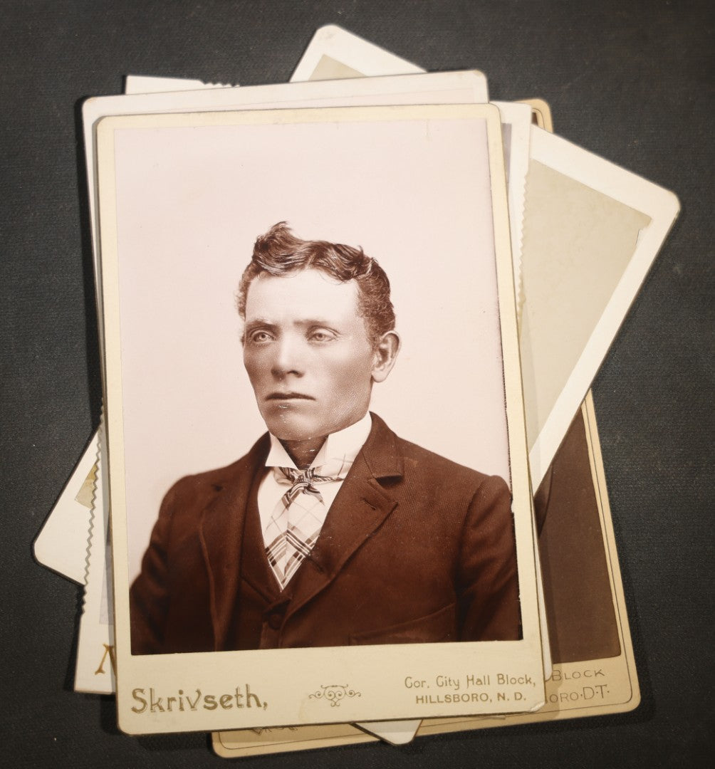 Grouping of Nine Antique Cabinet Card Photographs of Men including Examples by McInnis, Skrivseth, and Flaten