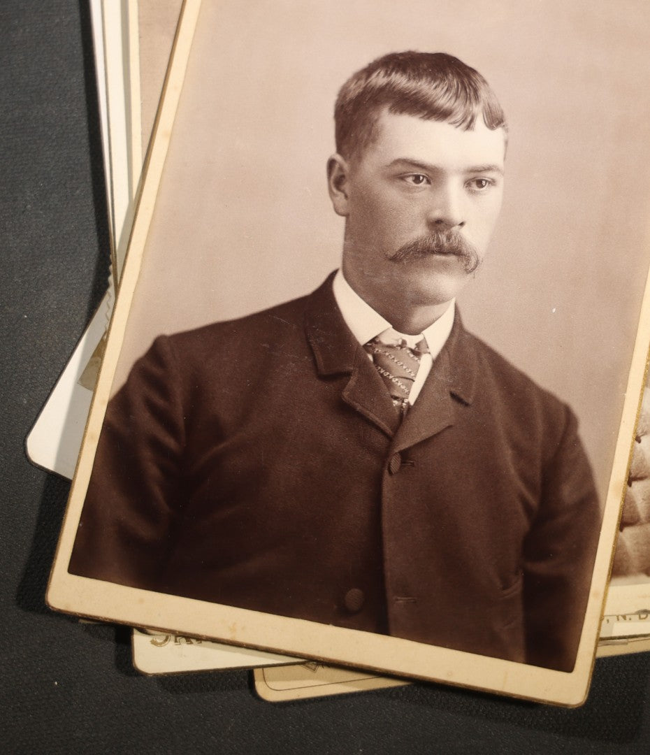 Grouping of Nine Antique Cabinet Card Photographs of Men including Examples by McInnis, Skrivseth, and Flaten