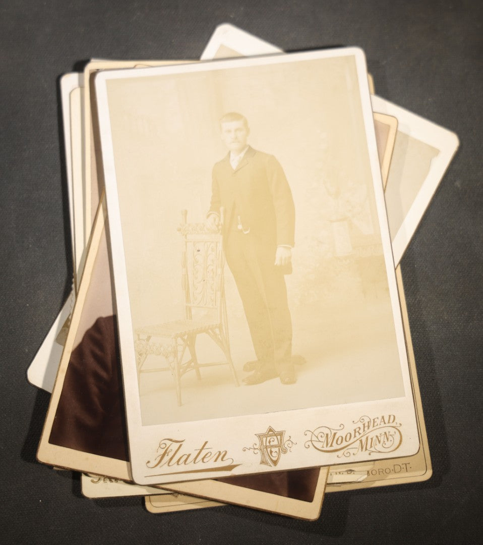 Grouping of Nine Antique Cabinet Card Photographs of Men including Examples by McInnis, Skrivseth, and Flaten