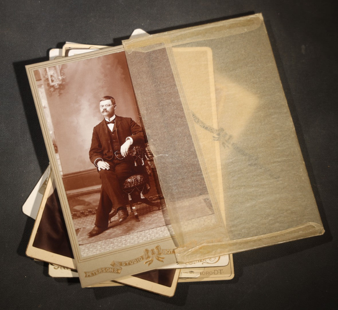 Grouping of Nine Antique Cabinet Card Photographs of Men including Examples by McInnis, Skrivseth, and Flaten