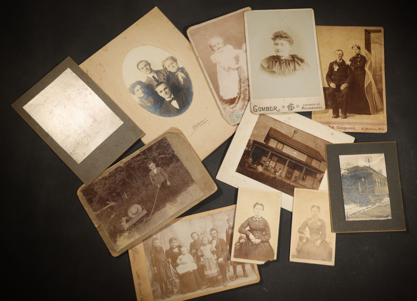 Grouping of 10 Antique and Vintage Photographs including a Boy with Wagon, a Railroad Car, C.D.V.s, cabinet cards, and Family Groups