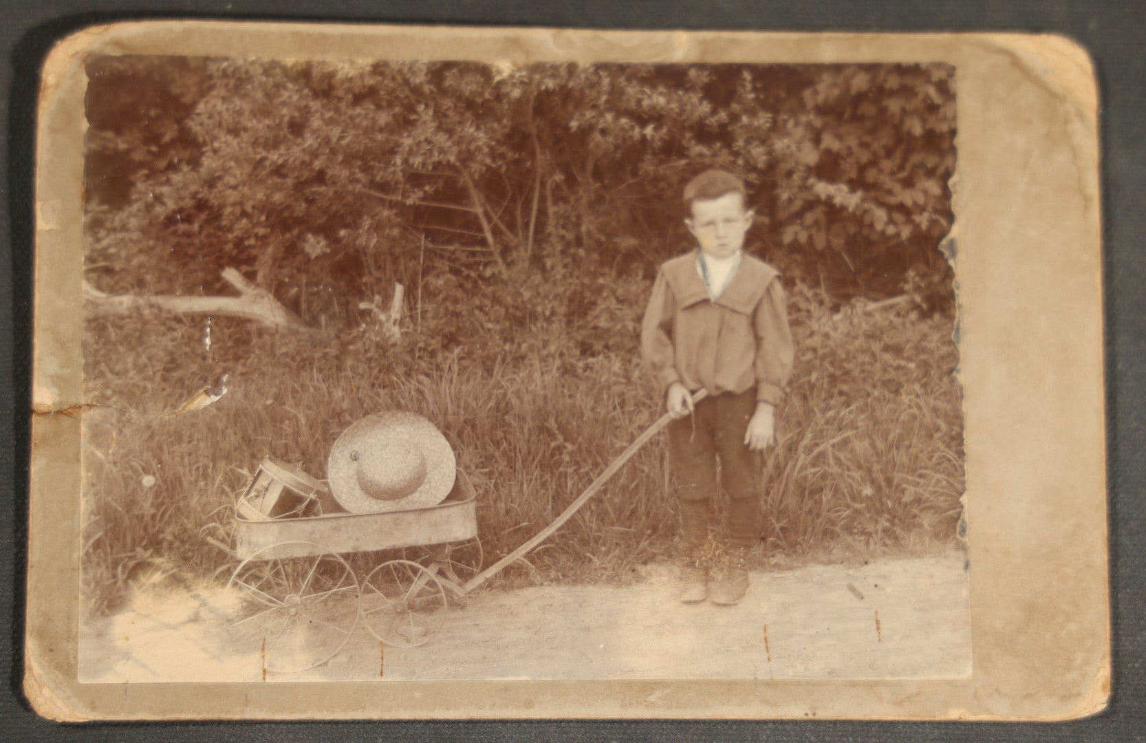 Grouping of 10 Antique and Vintage Photographs including a Boy with Wagon, a Railroad Car, C.D.V.s, cabinet cards, and Family Groups