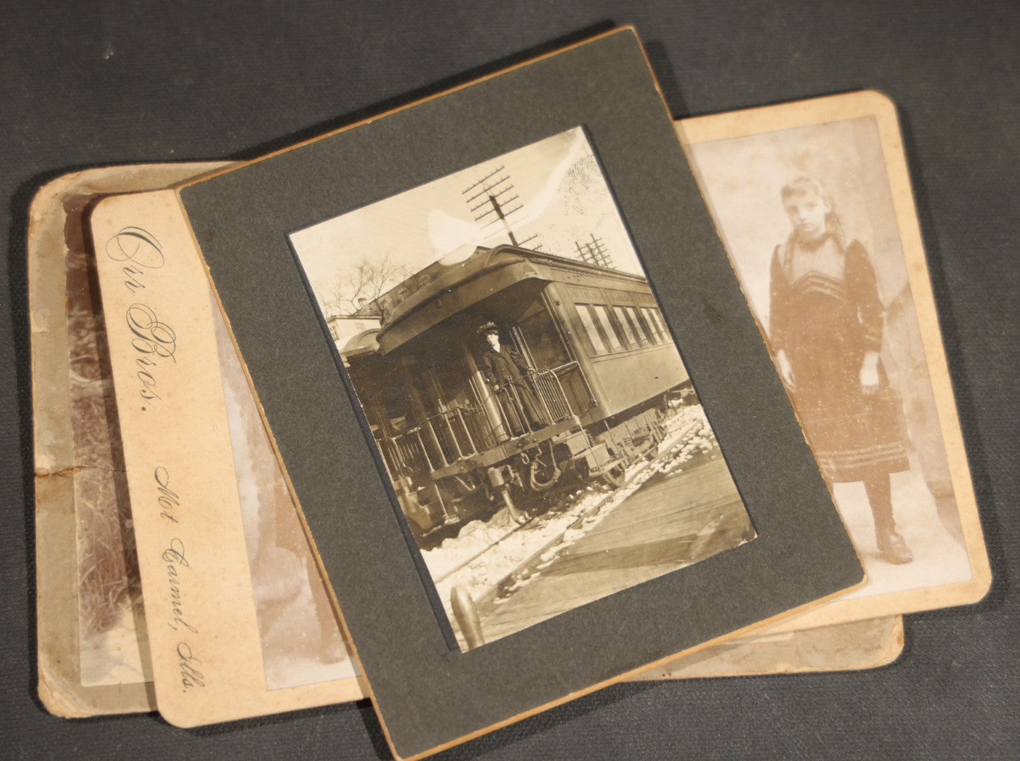 Grouping of 10 Antique and Vintage Photographs including a Boy with Wagon, a Railroad Car, C.D.V.s, cabinet cards, and Family Groups