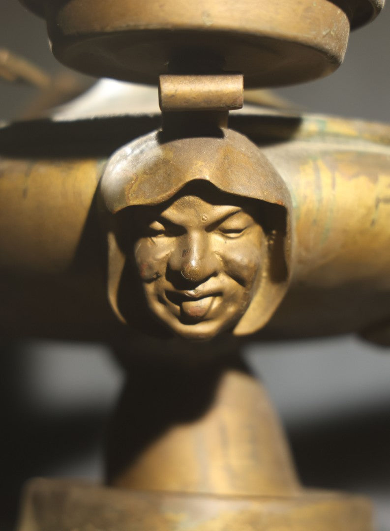 Antique Brass Four-Burner Oil Lamp with Monk Faces Sticking Out Tongues, Missing Two Burners