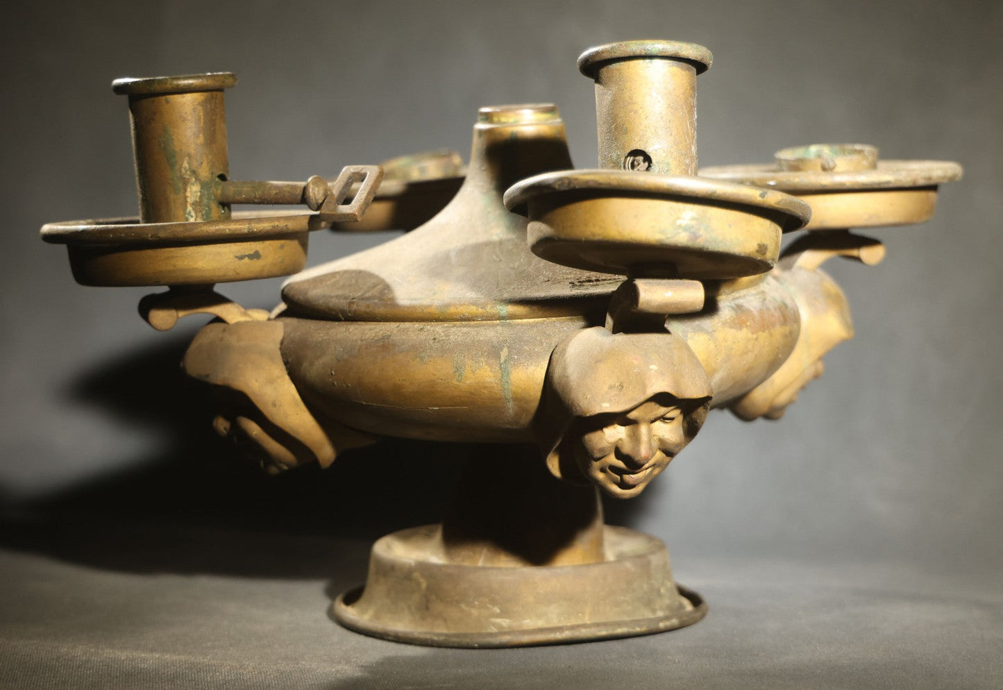 Antique Brass Four-Burner Oil Lamp with Monk Faces Sticking Out Tongues, Missing Two Burners