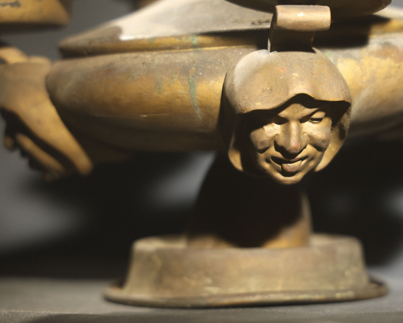 Antique Brass Four-Burner Oil Lamp with Monk Faces Sticking Out Tongues, Missing Two Burners