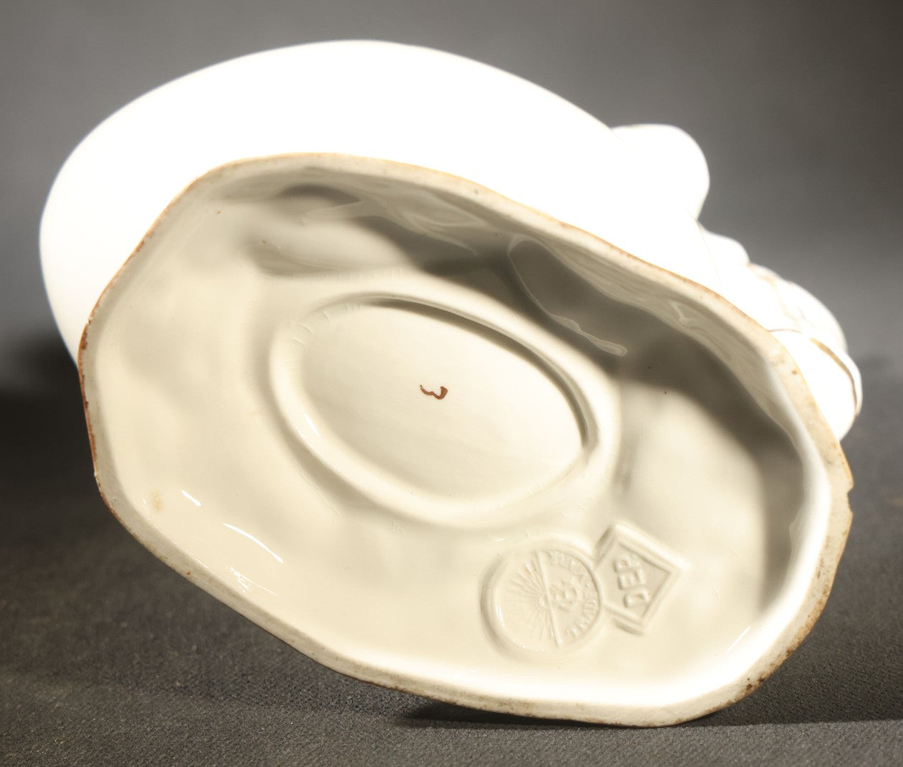 Antique Porcelain Figurine of Child in Stocking Cap Looking into Large Egg, Manufactured by Gebruder Heubach, Lichten, Germany, Note Chip