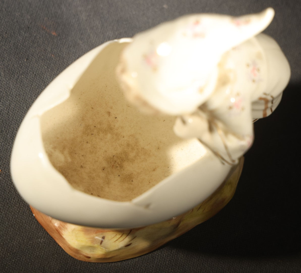 Antique Porcelain Figurine of Child in Stocking Cap Looking into Large Egg, Manufactured by Gebruder Heubach, Lichten, Germany, Note Chip