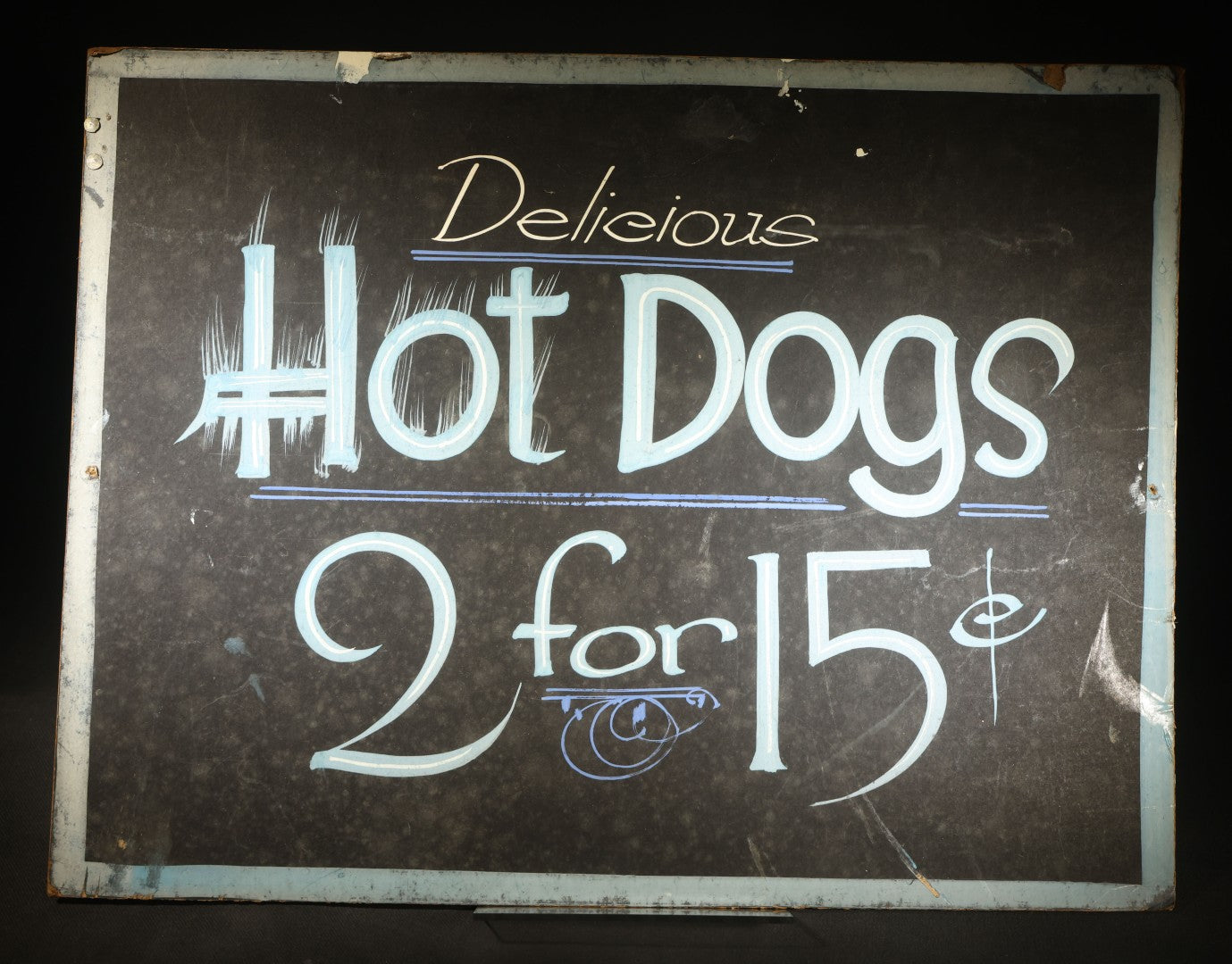 Vintage Hand-Lettered Paperboard Hot Dog Stand Sign "Delicious Hot Dogs 2 for 15¢" with White and Blue Paint on Black Background