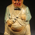 Lot 047 - Vintage Chalkware Novelty Figure of a Squatting Man Pooping with Pants Down, Missing Pipe, 5-1/4" H