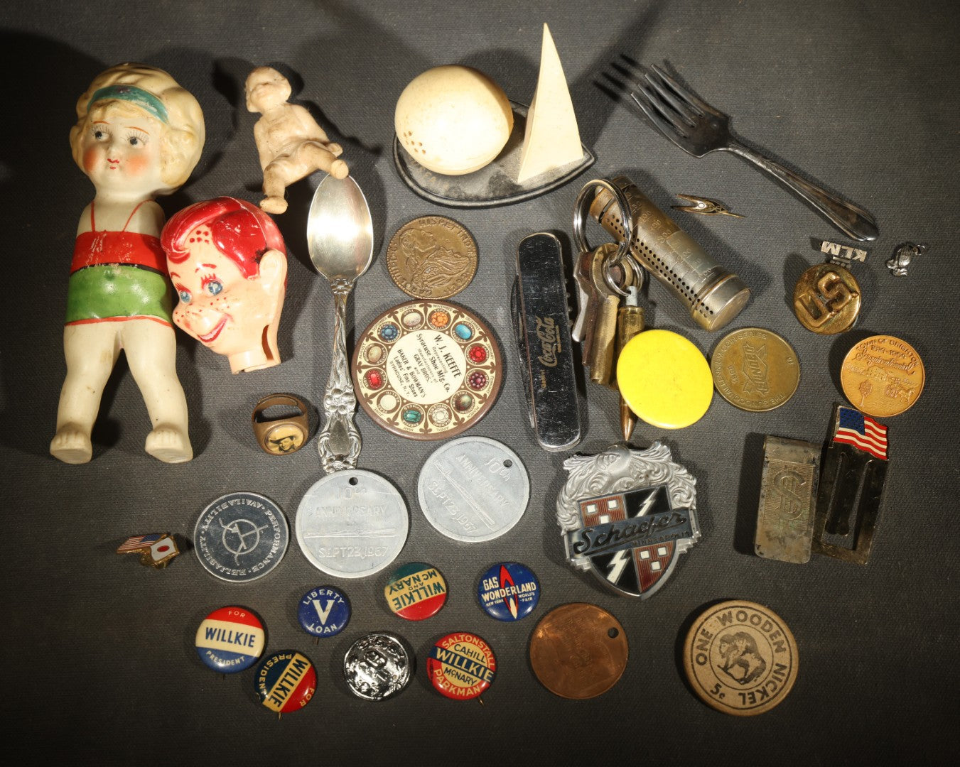 Vintage Junk Drawer Lot Including Bisque Doll, Howdy Doody Head Political Campaign Pins, Advertising Pocket Mirror, Tokens, Keys, and Silverplate Flatware