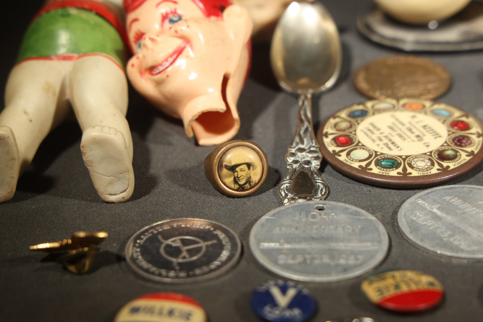Vintage Junk Drawer Lot Including Bisque Doll, Howdy Doody Head Political Campaign Pins, Advertising Pocket Mirror, Tokens, Keys, and Silverplate Flatware