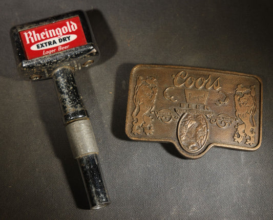 Pair of Vintage Beer Advertising Items including Rheingold Extra Dry Lager Beer Tap Handle and Reproduction Coors Banquet Beer Brass Belt Buckle with Lions and Barrel Design, Manufactured by Adolph Coors Company, Golden, Colorado