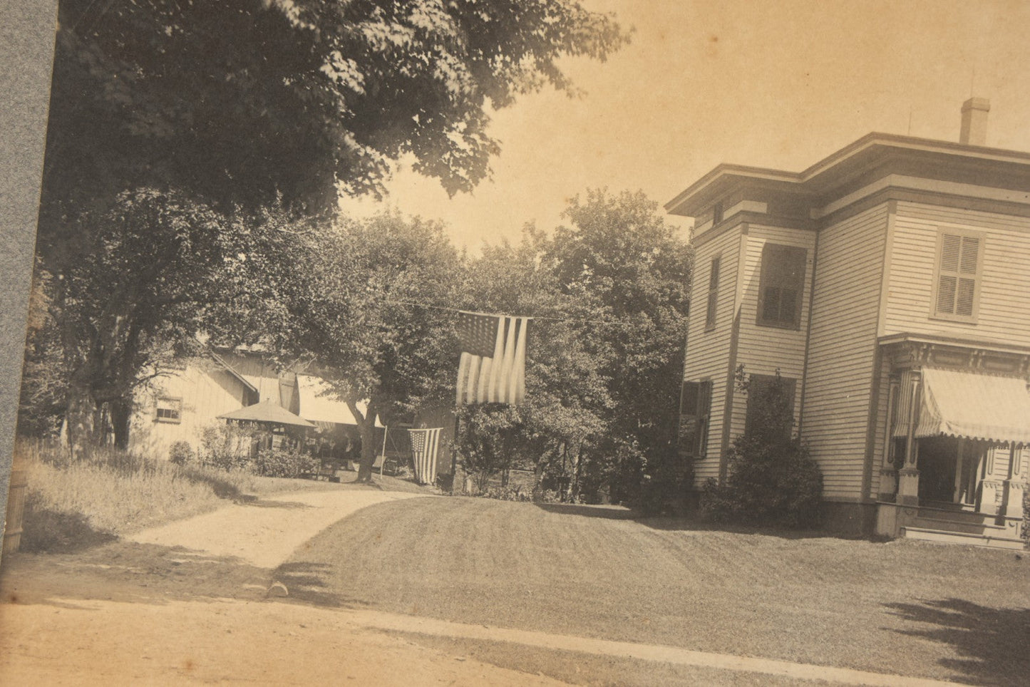 Trio of Vintage Board-Mounted Photographs Including Two-Story House with American Flags, Multi-Story Industrial Building with Gathered Crowd and High Wheel Bicycle, and Small Railroad Depot