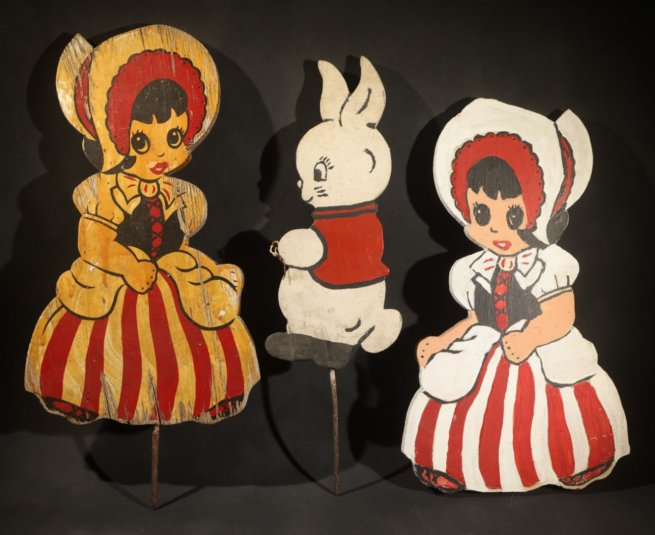 Trio of Vintage Folk Art Painted Wood Lawn Ornaments Including Two Girls in Bonnets with Red and White Striped Skirts and White Rabbit