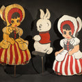 Lot 085 - Trio of Vintage Folk Art Painted Wood Lawn Ornaments Including Two Girls in Bonnets with Red and White Striped Skirts and White Rabbit