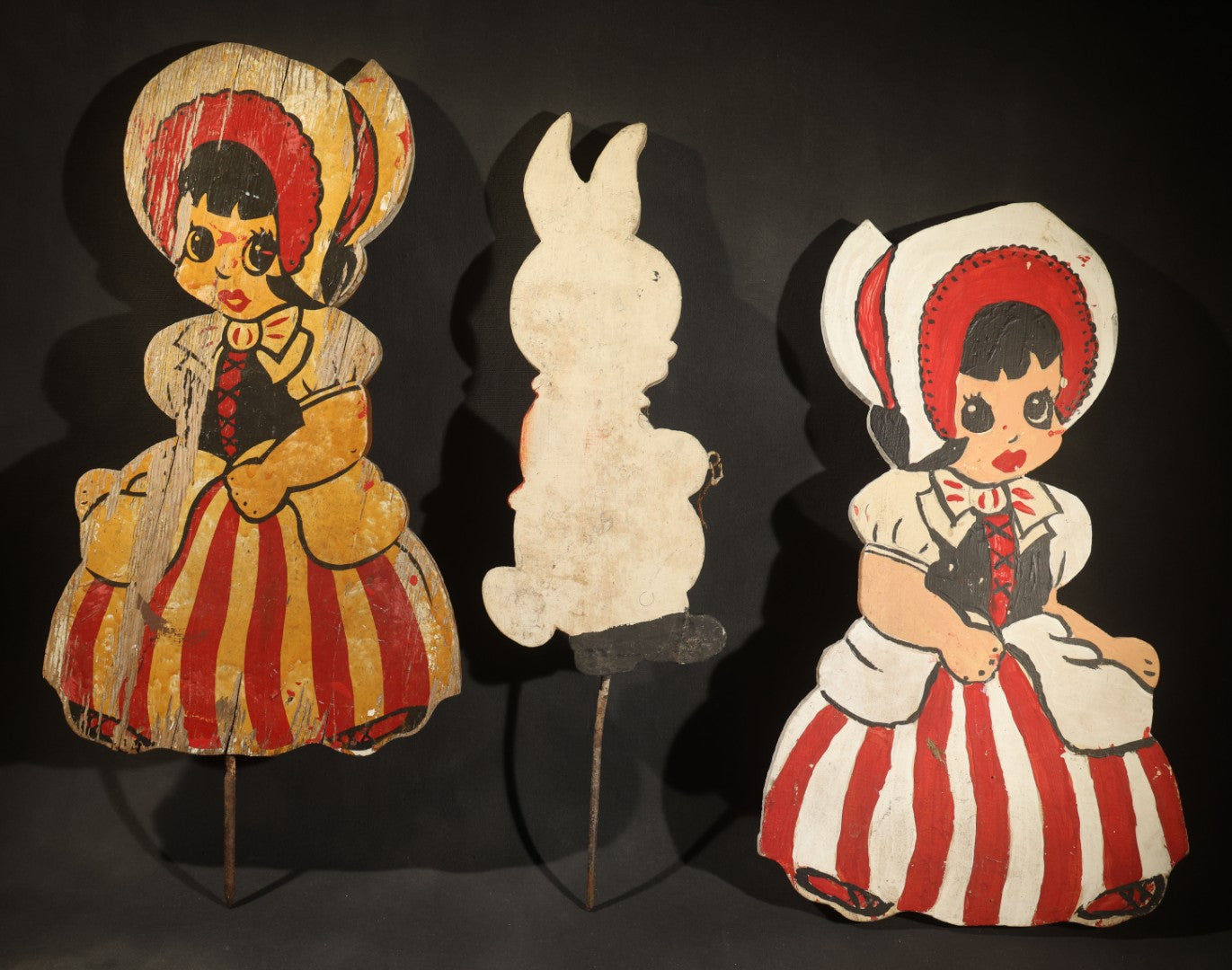 Trio of Vintage Folk Art Painted Wood Lawn Ornaments Including Two Girls in Bonnets with Red and White Striped Skirts and White Rabbit