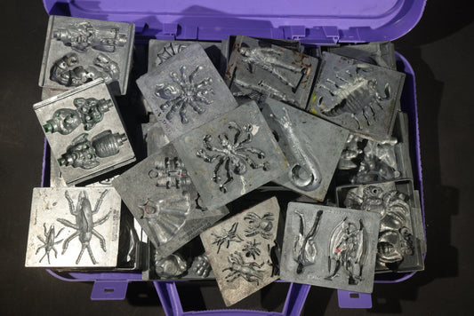Grouping of 47 Vintage Creepy Crawler Metal Molds including Spiders, Skulls, Insects, and Monsters, Mostly Copyright 1994 by Toymax, with Purple Plastic Toymax Carrying Case
