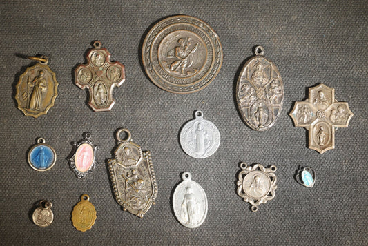 Grouping of 11 Antique and Vintage Religious Medals including Four Sterling Silver Examples with Various Saints, Miraculous Medal, Sacred Heart, and Crucifix Motifs
