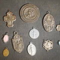 Lot 055 - Grouping of 11 Antique and Vintage Religious Medals Including Four Sterling Silver Examples with Various Saints, Miraculous Medal, Sacred Heart, and Crucifix Motifs