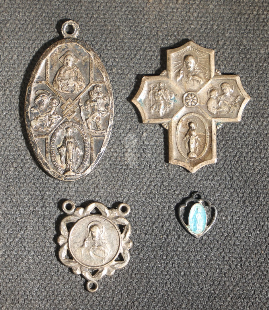 Grouping of 11 Antique and Vintage Religious Medals including Four Sterling Silver Examples with Various Saints, Miraculous Medal, Sacred Heart, and Crucifix Motifs