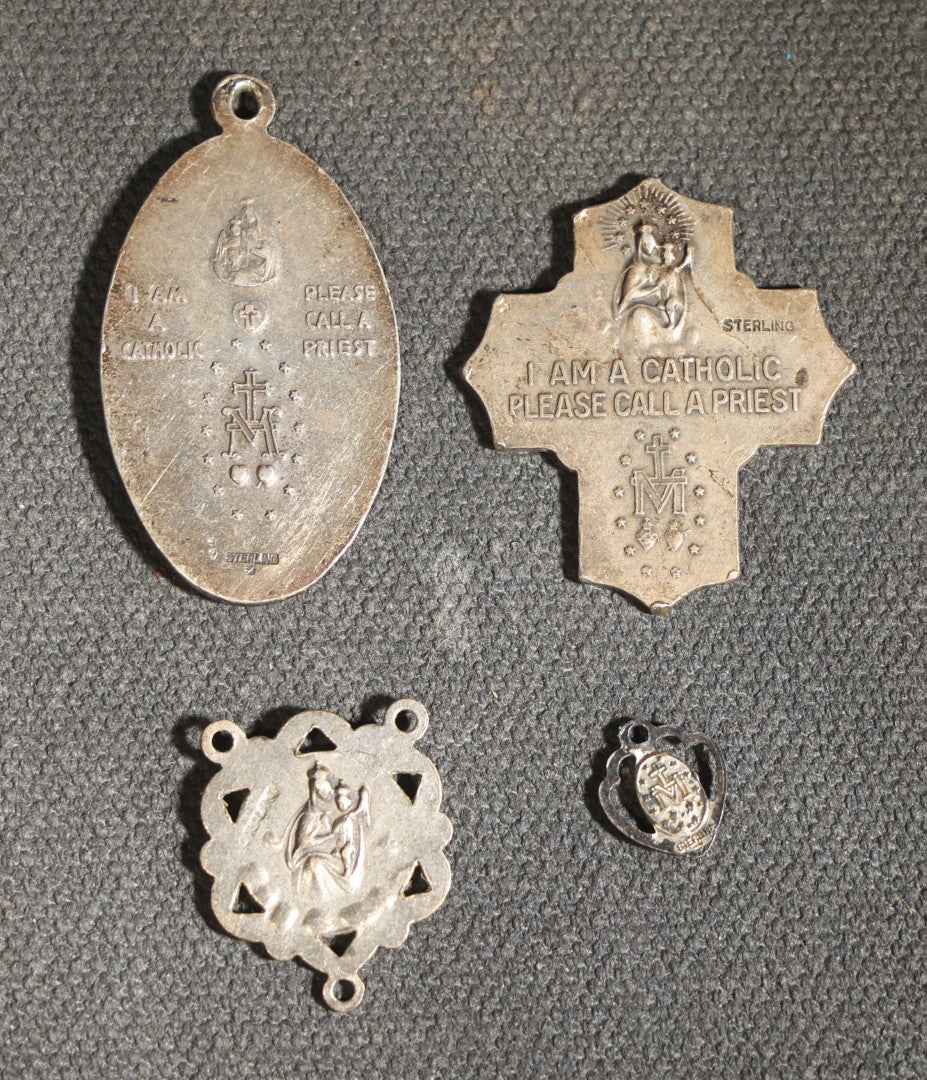 Grouping of 11 Antique and Vintage Religious Medals including Four Sterling Silver Examples with Various Saints, Miraculous Medal, Sacred Heart, and Crucifix Motifs