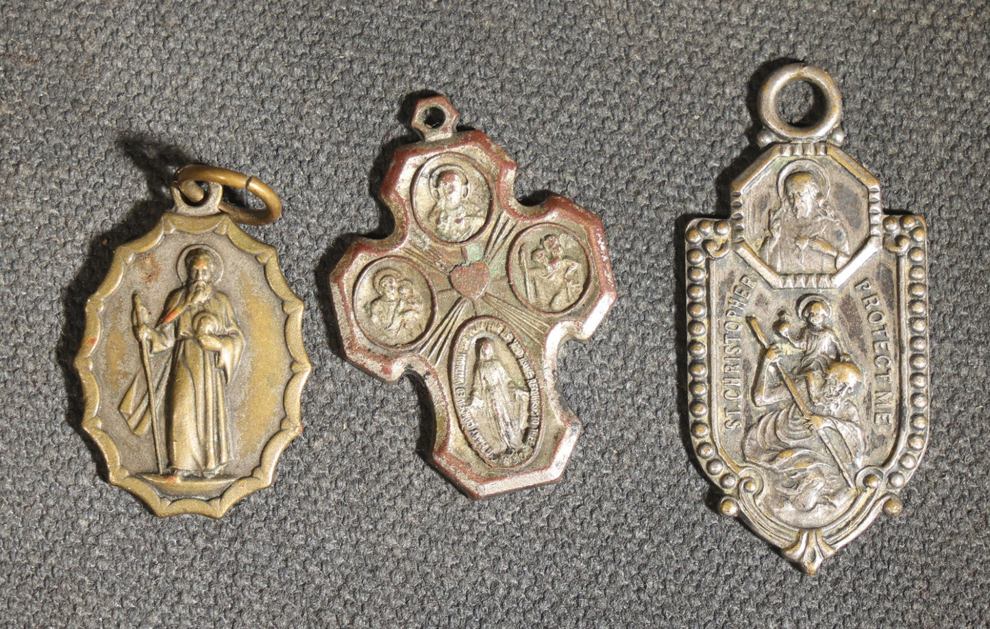 Grouping of 11 Antique and Vintage Religious Medals including Four Sterling Silver Examples with Various Saints, Miraculous Medal, Sacred Heart, and Crucifix Motifs