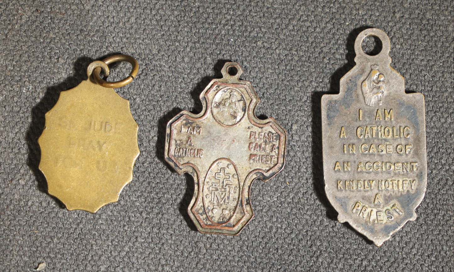 Grouping of 11 Antique and Vintage Religious Medals including Four Sterling Silver Examples with Various Saints, Miraculous Medal, Sacred Heart, and Crucifix Motifs