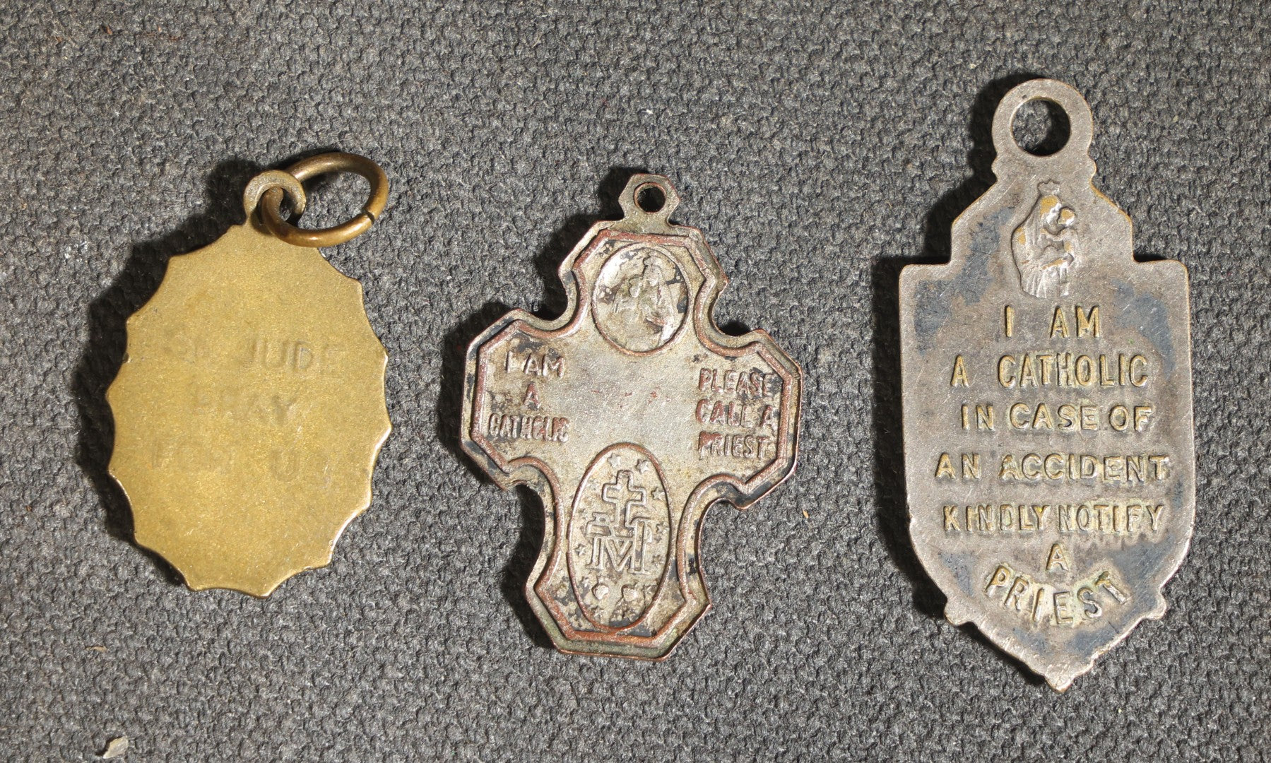 Grouping of 11 Antique and Vintage Religious Medals including Four Sterling Silver Examples with Various Saints, Miraculous Medal, Sacred Heart, and Crucifix Motifs