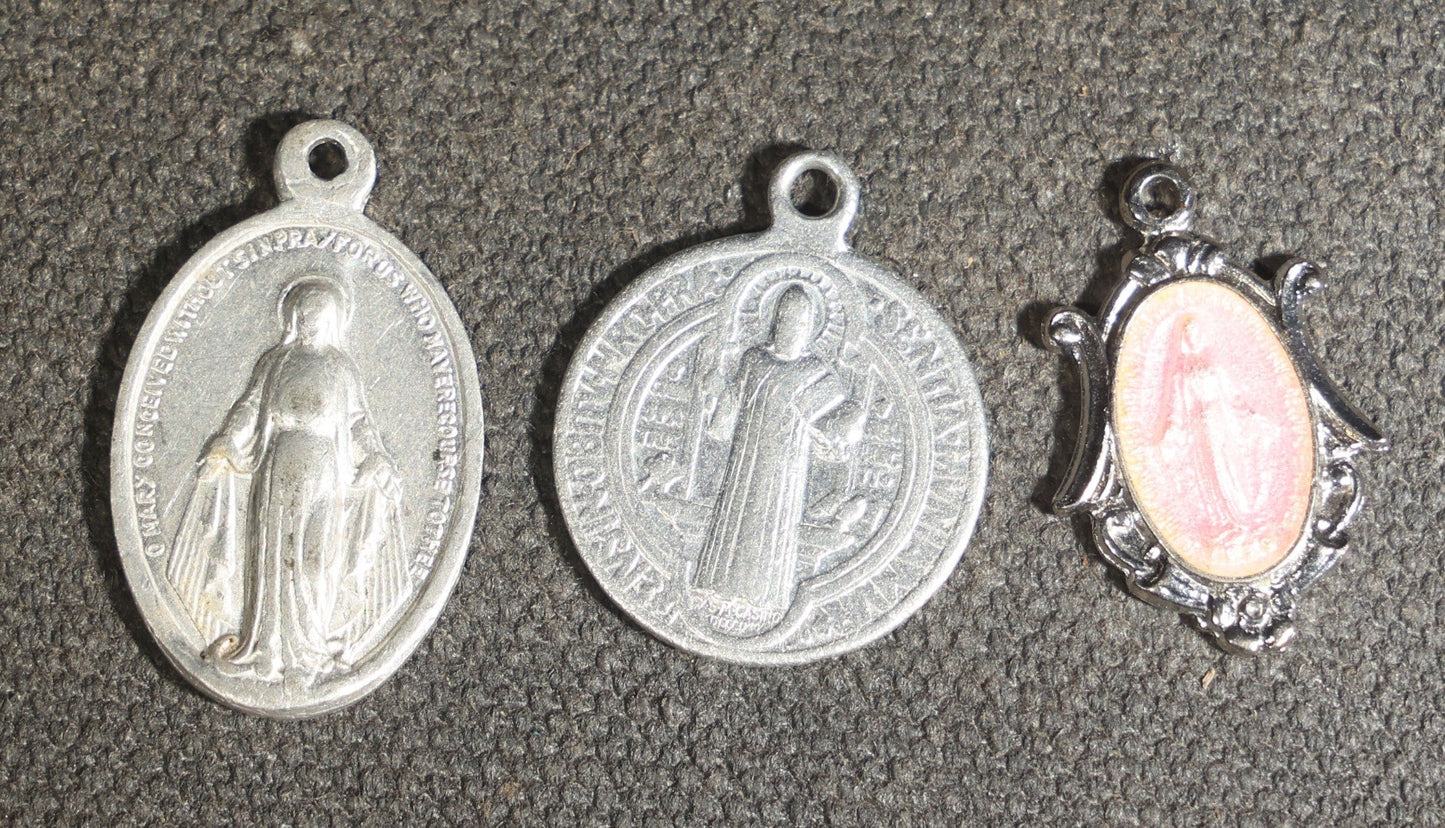 Grouping of 11 Antique and Vintage Religious Medals including Four Sterling Silver Examples with Various Saints, Miraculous Medal, Sacred Heart, and Crucifix Motifs